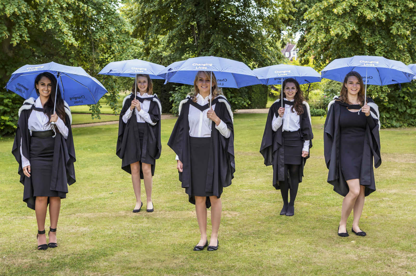 Students holding Changing Lives umbrellas
