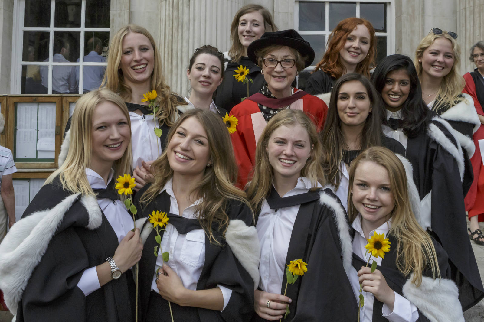 Students graduating with sunflowers