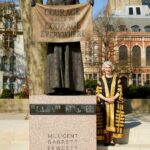 Dame Vivien Rose, in court robes, stands beside the statue of Dame Millicent Garrett Fawcett