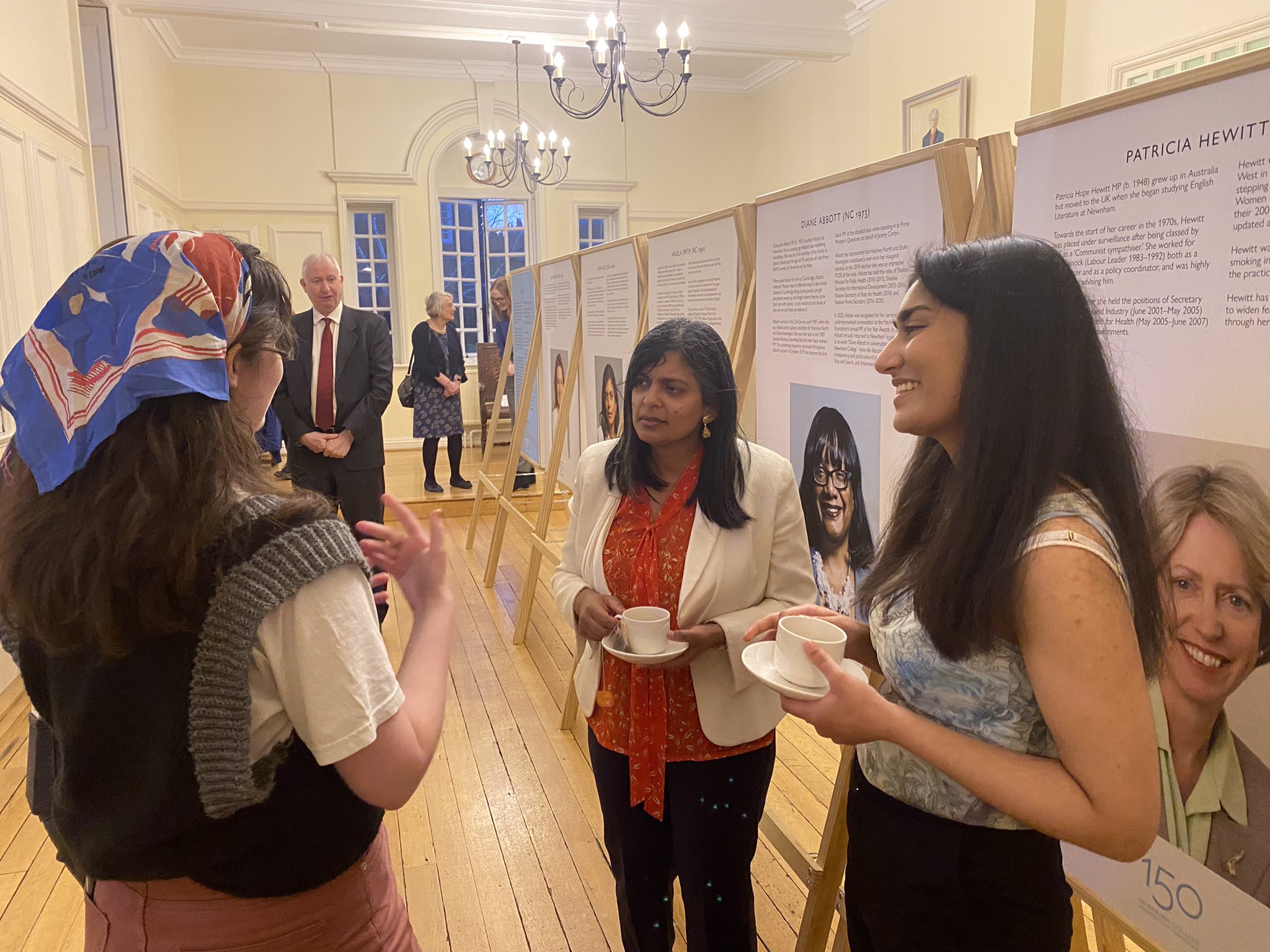 Rupa Huq MP and two students standing in front of a display board