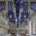 Banners hanging from the ceiling of a large hall