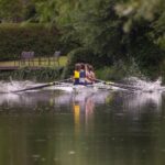Boat rowing towards the viewer on a river